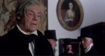 Movie still from “Nosferatu the Vampyre” (1979), directed by Werner Herzog – An old man in a black suit and a black top hat; Close Up shot, Over the shoulder angle