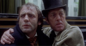 Movie still from “Nosferatu the Vampyre” (1979), directed by Werner Herzog – Two men in top hats and suits posing for a picture; Close Up shot, Low angle