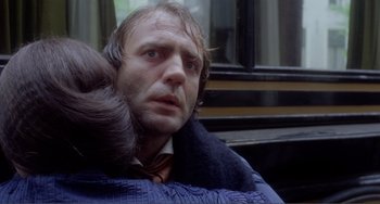 Movie still from “Nosferatu the Vampyre” (1979), directed by Werner Herzog – A person wearing a suit and tie; Close Up shot, Over the shoulder angle