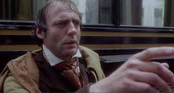 Movie still from “Nosferatu the Vampyre” (1979), directed by Werner Herzog – A person wearing a suit and tie; Close Up shot, Over the shoulder angle