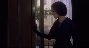 Movie still from “Nosferatu the Vampyre” (1979), directed by Werner Herzog – A woman standing in front of an open door; Medium shot, Over the shoulder angle