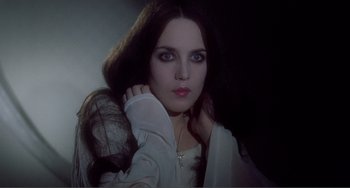 Movie still from “Nosferatu the Vampyre” (1979), directed by Werner Herzog – A woman with long dark brown hair wearing a white shirt; Close Up shot, Low angle