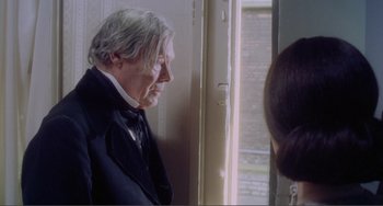 Movie still from “Nosferatu the Vampyre” (1979), directed by Werner Herzog – An older man in a suit and bow tie looking out of a window; Close Up shot, Over the shoulder angle