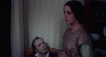Movie still from “Nosferatu the Vampyre” (1979), directed by Werner Herzog – A man and a woman sitting next to each other in a room; Medium shot, Over the shoulder angle
