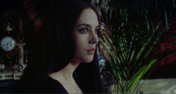 Movie still from “Nosferatu the Vampyre” (1979), directed by Werner Herzog – A woman with long black hair and blue eyes looking to her left; Close Up shot, Over the shoulder angle