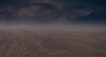 Movie still from “Nosferatu the Vampyre” (1979), directed by Werner Herzog – A person is standing in the middle of the desert; Extreme Wide shot, High angle