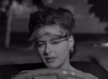 Movie still from “Notorious” (1946), directed by Alfred Hitchcock – A black - and - white photo of a woman's face; Close Up shot, Over the shoulder angle