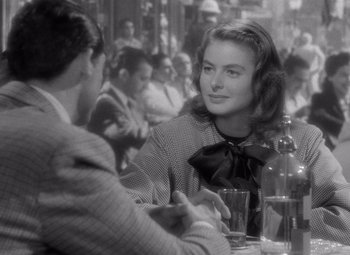 Movie still from “Notorious” (1946), directed by Alfred Hitchcock – A woman sitting at a table in front of a man; Medium shot, Over the shoulder angle
