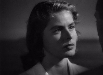 Movie still from “Notorious” (1946), directed by Alfred Hitchcock – A black - and - white photo of a young woman; Close Up shot, Over the shoulder angle