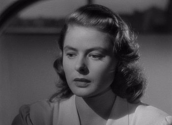 Movie still from “Notorious” (1946), directed by Alfred Hitchcock – A black - and - white photo of a woman looking to her left; Close Up shot, Over the shoulder angle