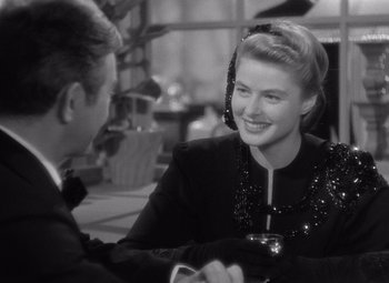 Movie still from “Notorious” (1946), directed by Alfred Hitchcock – A man and a woman sitting at a dinner table; Close Up shot, Over the shoulder angle