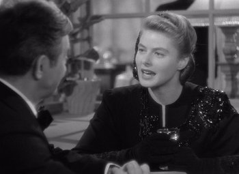 Movie still from “Notorious” (1946), directed by Alfred Hitchcock – A man and a woman sitting at a dinner table; Close Up shot, Over the shoulder angle