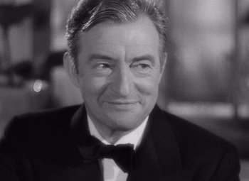 Movie still from “Notorious” (1946), directed by Alfred Hitchcock – Black and white photograph of a man in a tuxedo; Close Up shot, High angle