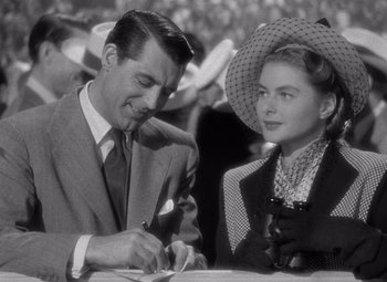 Movie still from “Notorious” (1946), directed by Alfred Hitchcock – A man and a woman sitting at a table with wine; Close Up shot, Over the shoulder angle