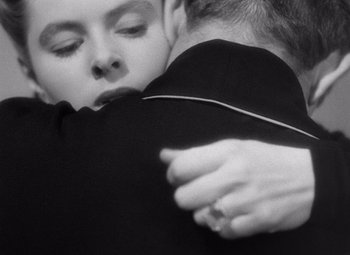 Movie still from “Notorious” (1946), directed by Alfred Hitchcock – A man and a woman hugging each other; Extreme Close Up shot, Overhead angle