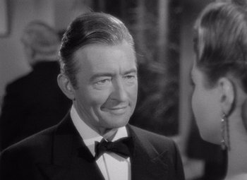 Movie still from “Notorious” (1946), directed by Alfred Hitchcock – An older man wearing a suit and bow tie; Close Up shot, Over the shoulder angle