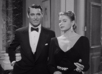 Movie still from “Notorious” (1946), directed by Alfred Hitchcock – A man and a woman standing next to each other; Medium shot, Low angle