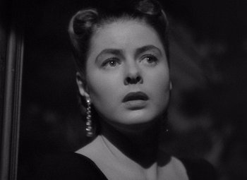 Movie still from “Notorious” (1946), directed by Alfred Hitchcock – A black and white photo of a woman in a black dress; Close Up shot, Low angle