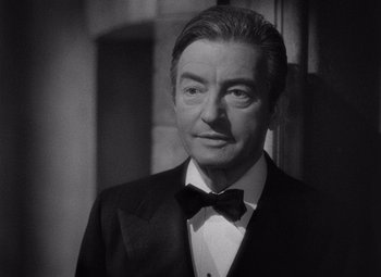 Movie still from “Notorious” (1946), directed by Alfred Hitchcock – Black and white photograph of a man in a tuxedo; Close Up shot, Low angle