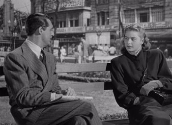 Movie still from “Notorious” (1946), directed by Alfred Hitchcock – A man and a woman sitting on a park bench; Medium shot, Over the shoulder angle