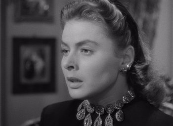 Movie still from “Notorious” (1946), directed by Alfred Hitchcock – A black and white photo of a woman wearing a necklace; Close Up shot, Over the shoulder angle