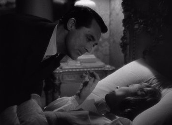 Movie still from “Notorious” (1946), directed by Alfred Hitchcock – A black and white photo of a man and a woman; Close Up shot, High angle