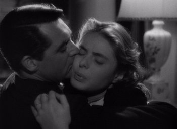 Movie still from “Notorious” (1946), directed by Alfred Hitchcock – A man and a woman are kissing in a room; Close Up shot, High angle