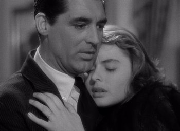 Movie still from “Notorious” (1946), directed by Alfred Hitchcock – A man and a woman embracing each other in a black and white photo; Close Up shot, Low angle