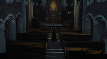 Movie still from “Novitiate” (2017), directed by Maggie Betts – A woman sitting in front of the altar in a church; Extreme Wide shot, High angle