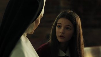 Movie still from “Novitiate” (2017), directed by Maggie Betts – A young girl looking at a nun in the mirror; Close Up shot, Over the shoulder angle
