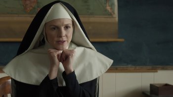 Movie still from “Novitiate” (2017), directed by Maggie Betts – A woman dressed as a nun in front of a chalkboard; Close Up shot, Low angle