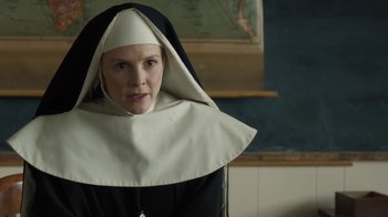 Movie still from “Novitiate” (2017), directed by Maggie Betts – A woman wearing a nun's outfit in front of a chalkboard; Close Up shot, Low angle
