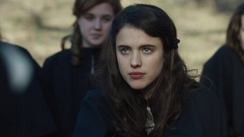 Movie still from “Novitiate” (2017), directed by Maggie Betts – Two young women sitting next to each other in a field; Close Up shot, Over the shoulder angle