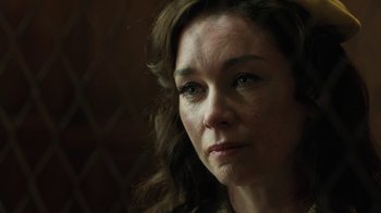 Movie still from “Novitiate” (2017), directed by Maggie Betts – A woman's face in a dark room; Close Up shot, Over the shoulder angle