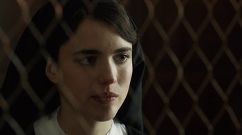 Movie still from “Novitiate” (2017), directed by Maggie Betts – A young woman looking out of a window; Close Up shot, Over the shoulder angle