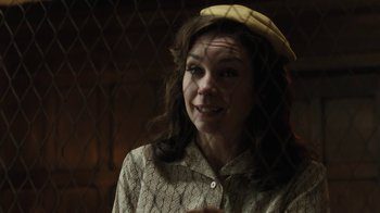 Movie still from “Novitiate” (2017), directed by Maggie Betts – A woman wearing a yellow hat is smiling for the camera; Close Up shot, Over the shoulder angle
