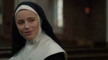 Movie still from “Novitiate” (2017), directed by Maggie Betts – A woman wearing a nun's outfit in front of a window; Close Up shot, Over the shoulder angle
