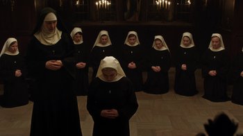 Movie still from “Novitiate” (2017), directed by Maggie Betts – A group of nuns standing in front of a wall; Wide shot, High angle