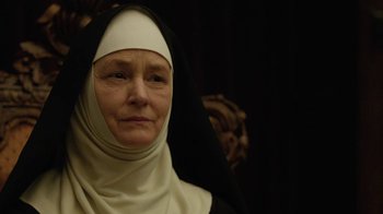 Movie still from “Novitiate” (2017), directed by Maggie Betts – An older woman wearing a nun's habit and veil; Close Up shot, Low angle