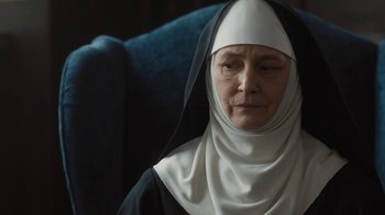 Movie still from “Novitiate” (2017), directed by Maggie Betts – An older woman wearing a nun's outfit; Close Up shot, Over the shoulder angle