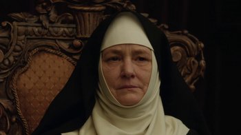 Movie still from “Novitiate” (2017), directed by Maggie Betts – An older woman wearing a nun's outfit; Close Up shot, Low angle