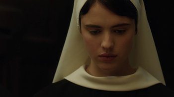 Movie still from “Novitiate” (2017), directed by Maggie Betts – A woman wearing a nun's hat looking to her left; Close Up shot, High angle