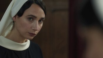 Movie still from “Novitiate” (2017), directed by Maggie Betts – A woman wearing a nun's outfit looking at the camera; Close Up shot, Over the shoulder angle