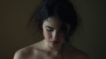 Movie still from “Novitiate” (2017), directed by Maggie Betts – A young woman with dark hair is looking down at her face; Close Up shot, High angle