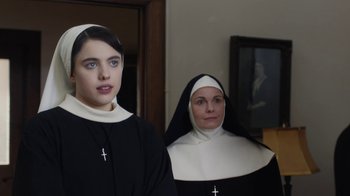 Movie still from “Novitiate” (2017), directed by Maggie Betts – Two women dressed in nun's clothes standing next to each other; Medium shot, Over the shoulder angle