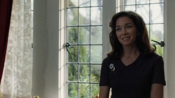 Movie still from “Novitiate” (2017), directed by Maggie Betts – A woman standing in front of a large window; Close Up shot, Over the shoulder angle