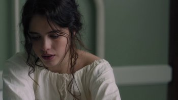 Movie still from “Novitiate” (2017), directed by Maggie Betts – A young woman in a white shirt is looking down; Close Up shot, Over the shoulder angle