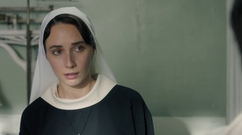 Movie still from “Novitiate” (2017), directed by Maggie Betts – A woman wearing a nun's outfit looking at the camera; Close Up shot, High angle