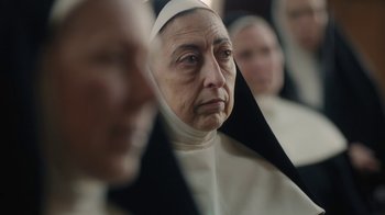 Movie still from “Novitiate” (2017), directed by Maggie Betts – An old woman wearing a nun's outfit looking into the camera; Close Up shot, Over the shoulder angle