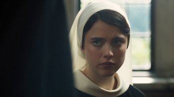 Movie still from “Novitiate” (2017), directed by Maggie Betts – A woman wearing a white head scarf and a black dress; Close Up shot, Over the shoulder angle